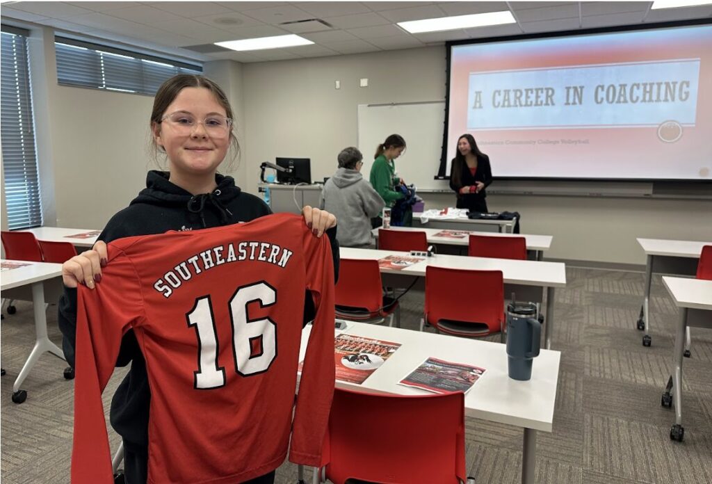 Student Brynn Robinson poses Dec. 19, 2024, with the SCC volleyball jersey she received at the session on coaching at Southeastern Community College. Robinson learned what coaches do for their athletes and teams behind the scenes. 